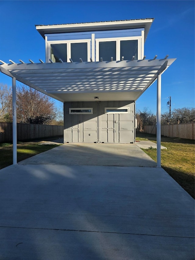 exterior space with a carport and a lawn