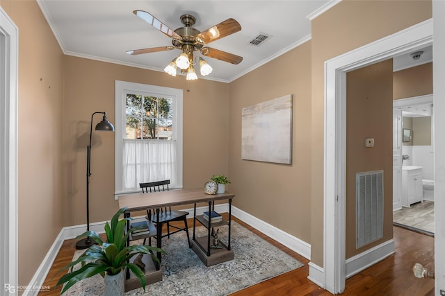 home office with hardwood / wood-style flooring, ceiling fan, and ornamental molding