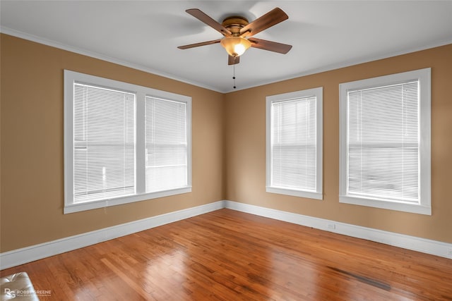 empty room with hardwood / wood-style floors, ceiling fan, and crown molding