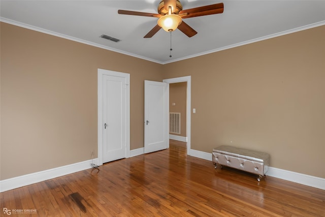 interior space featuring wood-type flooring, ceiling fan, and crown molding