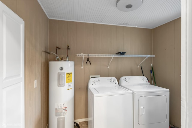 washroom with washing machine and dryer, wooden walls, and water heater