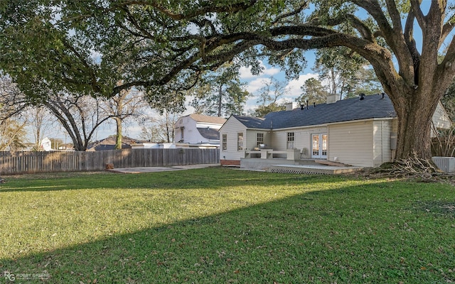 view of yard featuring central AC unit, a patio, and french doors