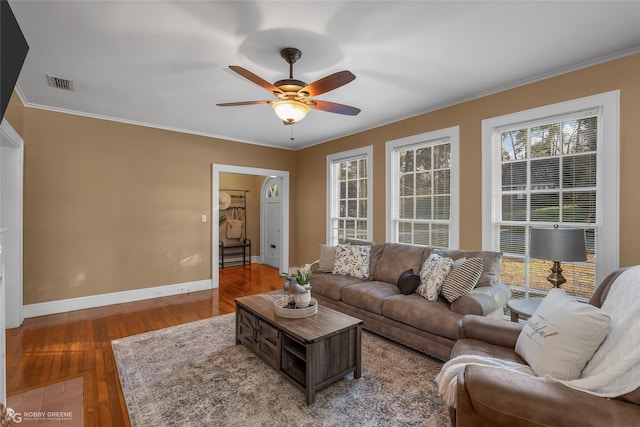 living room featuring hardwood / wood-style floors, ceiling fan, and ornamental molding