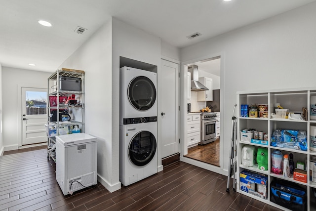 laundry area featuring stacked washing maching and dryer