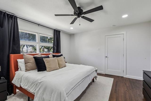 bedroom with ceiling fan and dark hardwood / wood-style flooring