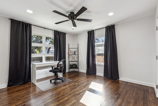 office area featuring dark wood-type flooring, built in desk, and ceiling fan