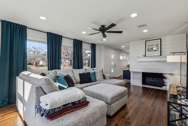 living room featuring hardwood / wood-style flooring, plenty of natural light, and ceiling fan