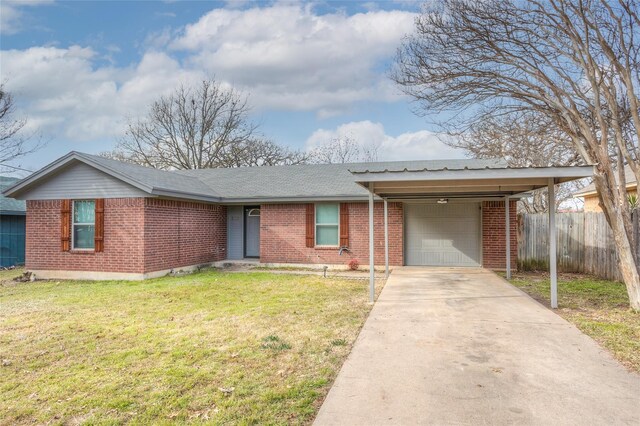 ranch-style house featuring a carport, a garage, and a front lawn