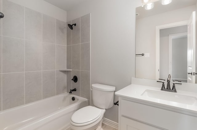 full bathroom featuring vanity, tiled shower / bath combo, and toilet