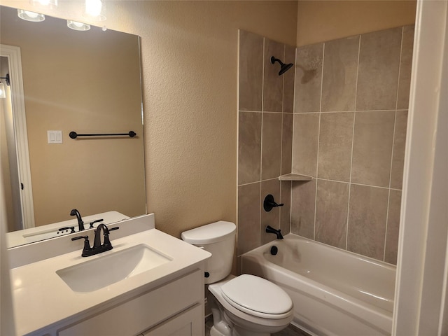 full bathroom featuring vanity, tiled shower / bath combo, and toilet