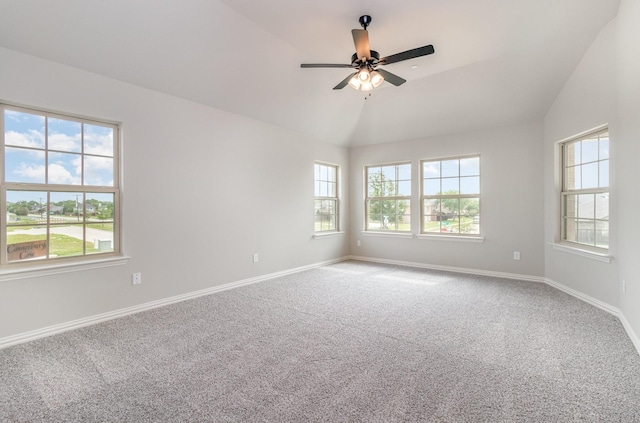 unfurnished room with carpet floors, a wealth of natural light, and vaulted ceiling