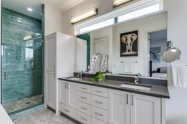 bathroom featuring vanity and an enclosed shower