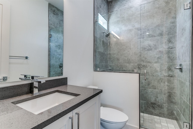 bathroom featuring walk in shower, vanity, and toilet