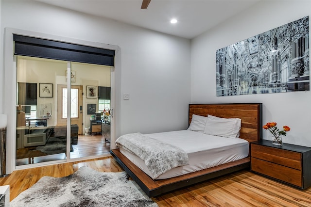 bedroom with ceiling fan and light hardwood / wood-style flooring