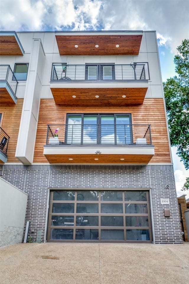 exterior space with a balcony and a garage