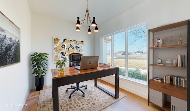 home office featuring a notable chandelier and light wood-type flooring