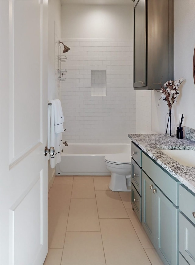 full bathroom with vanity, tiled shower / bath, tile patterned flooring, and toilet