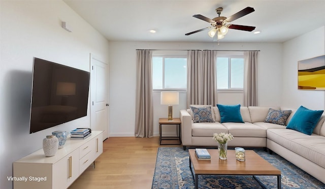 living room with ceiling fan and light wood-type flooring