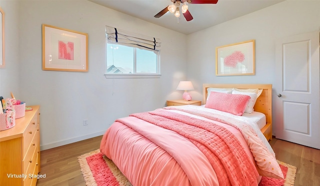 bedroom with ceiling fan and light hardwood / wood-style floors