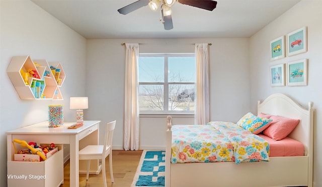 bedroom with ceiling fan and light hardwood / wood-style flooring