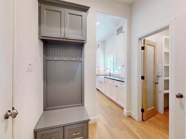 mudroom featuring sink and light hardwood / wood-style flooring