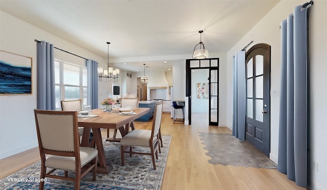 dining room with an inviting chandelier and light wood-type flooring