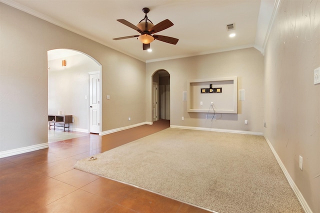 empty room with tile patterned floors, ceiling fan, and ornamental molding