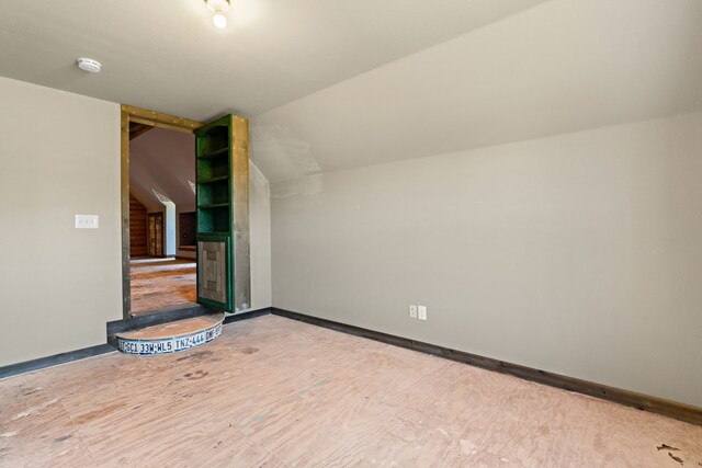 additional living space featuring vaulted ceiling