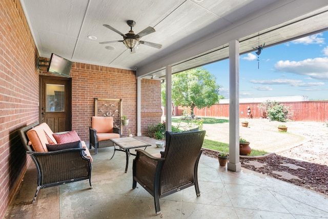 sunroom / solarium featuring ceiling fan