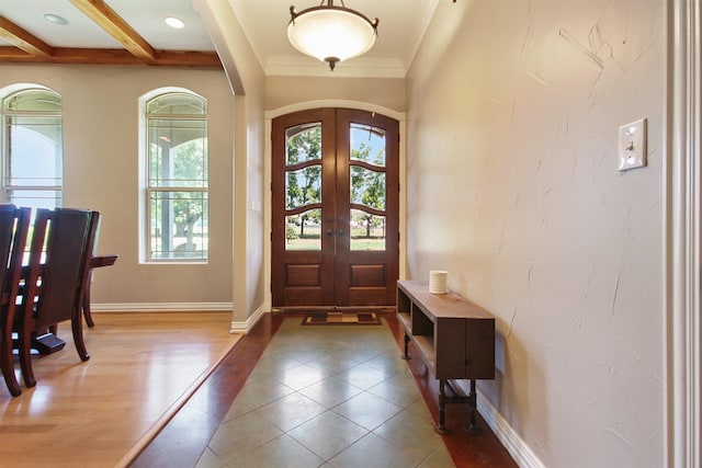 entrance foyer with french doors, ornamental molding, hardwood / wood-style floors, and beamed ceiling