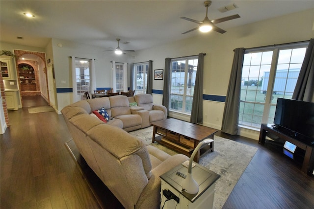 living room featuring dark hardwood / wood-style floors and ceiling fan