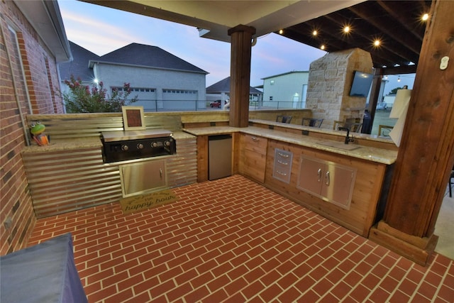 view of patio featuring an outdoor kitchen, grilling area, and sink