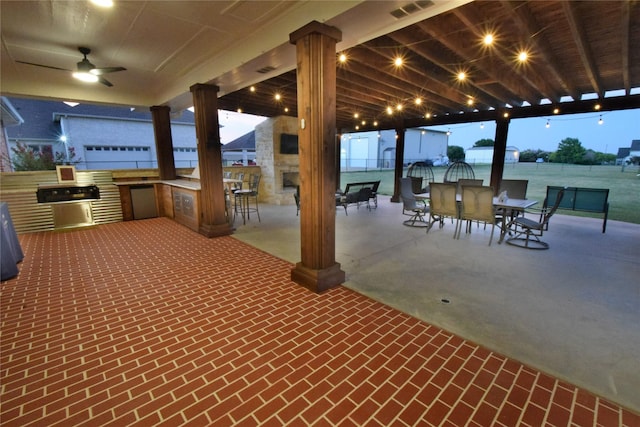 view of patio featuring grilling area, ceiling fan, and exterior kitchen