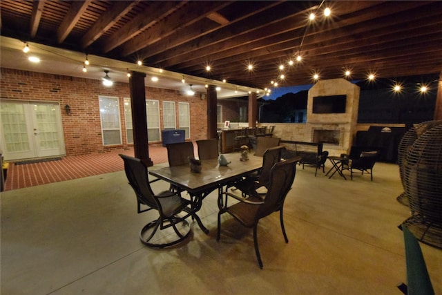 view of patio / terrace featuring an outdoor stone fireplace and french doors