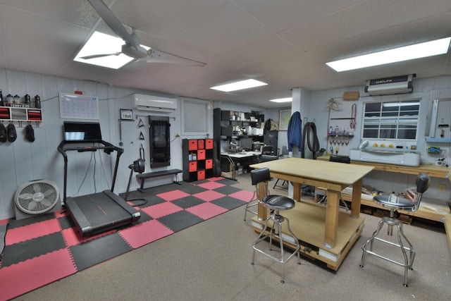 workout area with a wall unit AC and a workshop area