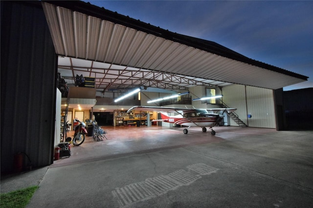 garage at night featuring a carport