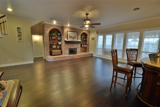 living room featuring dark hardwood / wood-style flooring, ceiling fan, and ornamental molding