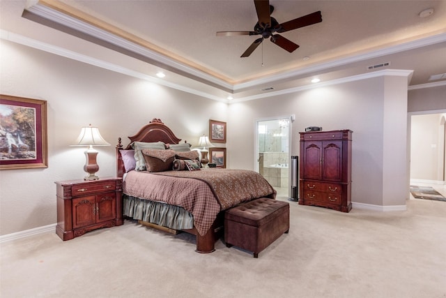 carpeted bedroom featuring crown molding, ceiling fan, ensuite bathroom, and a raised ceiling