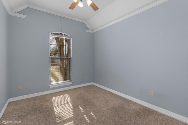 empty room featuring crown molding, vaulted ceiling, ceiling fan, and carpet