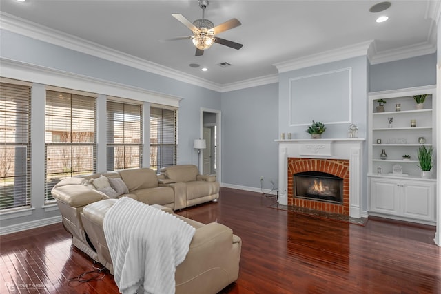 living room with ornamental molding, ceiling fan, a fireplace, and dark hardwood / wood-style flooring