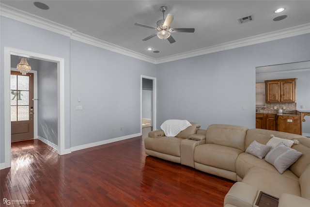 living room featuring ornamental molding, ceiling fan with notable chandelier, and dark hardwood / wood-style flooring