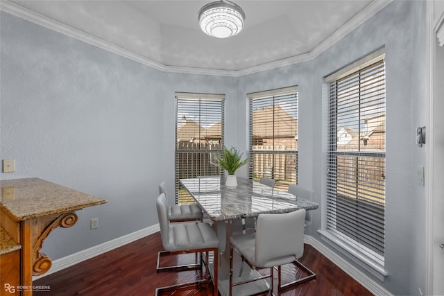 dining space featuring ornamental molding and dark hardwood / wood-style flooring