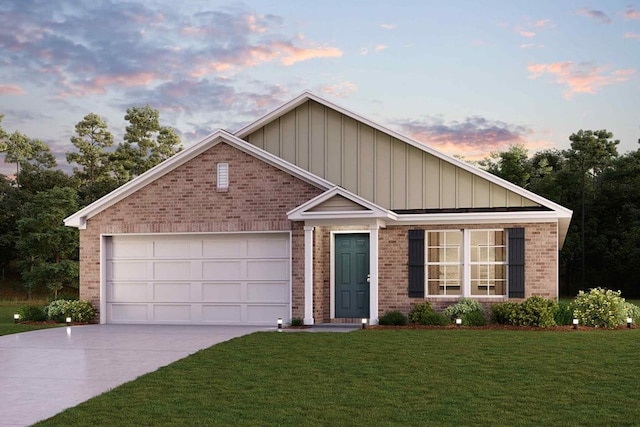 view of front of home with a lawn and a garage