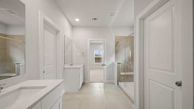 bathroom with tile patterned flooring, vanity, and a shower with shower door