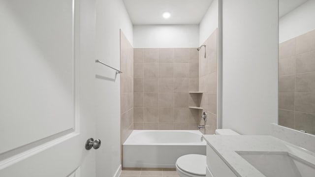 full bathroom featuring vanity, tile patterned flooring, tiled shower / bath combo, and toilet