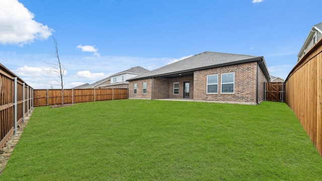 back of property featuring a yard and a patio area