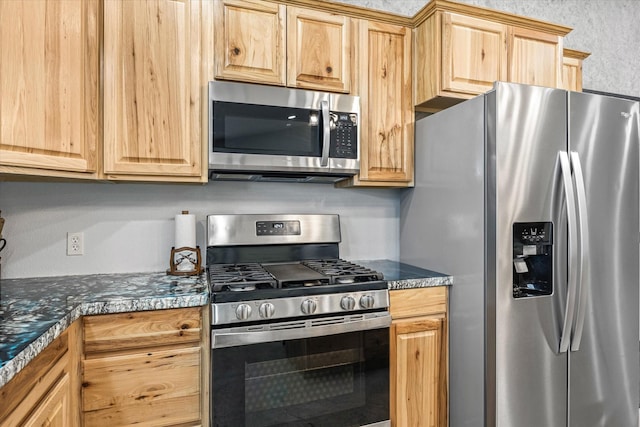 kitchen featuring light brown cabinets and stainless steel appliances