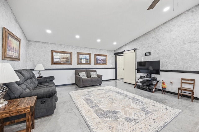 living room with a barn door, ceiling fan, and vaulted ceiling