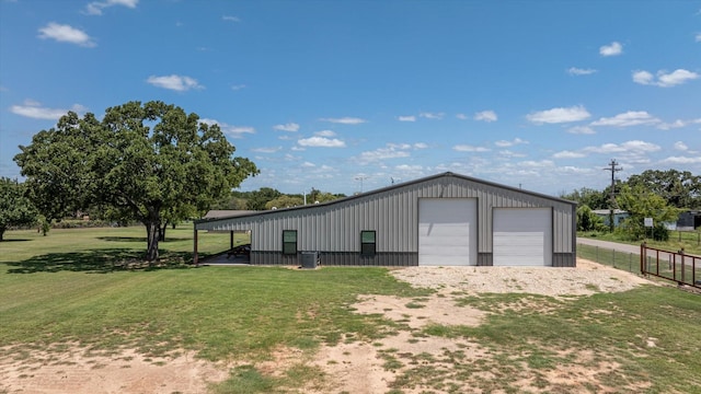 view of outbuilding featuring a garage and a yard