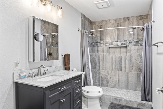 bathroom with vanity, a shower with shower curtain, and toilet